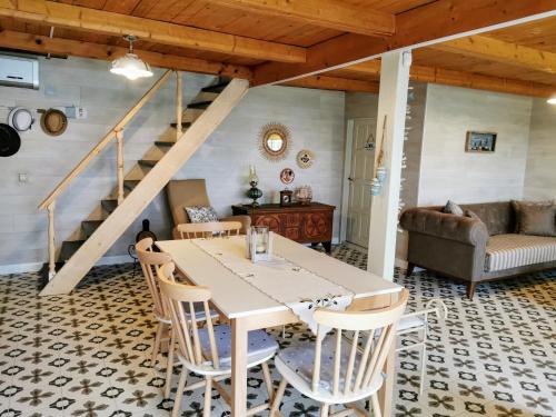 a dining room with a table and chairs at Beachfront, Tirana Guest House in Velipojë