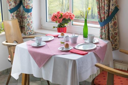 a table with a red and white table cloth on it at Lauras Landhauspension in Medebach