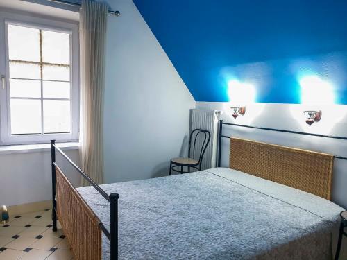 a bedroom with a bed with a blue ceiling at Cinnamon villa in Palanga