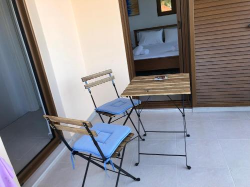 a table and two chairs in a room with a bed at Boutique Family Villa in Monastiraki