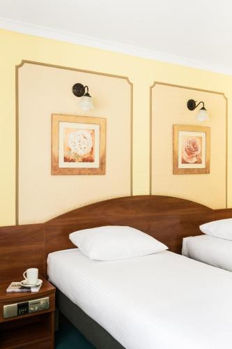 a hotel room with two beds and a table at Hotel Wersal in Zakopane
