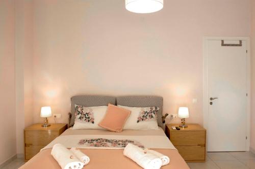 a bedroom with a bed with two pillows on it at NOURI APARTMENT in Corfu