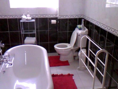 a bathroom with a white toilet and a sink at No 7 Priory Guest House in Dover