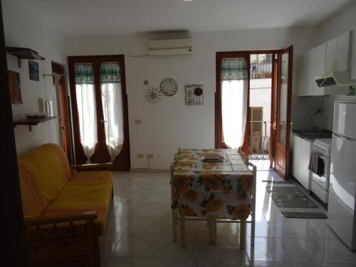 a living room with a table and a couch at Casa Orchidea in Lipari