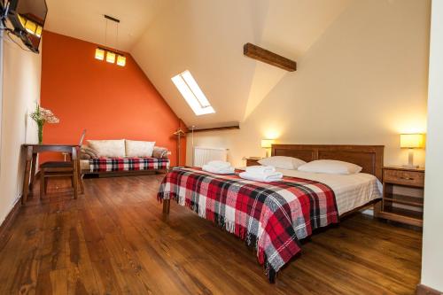 a bedroom with a bed and a couch at Korali in Yaremche