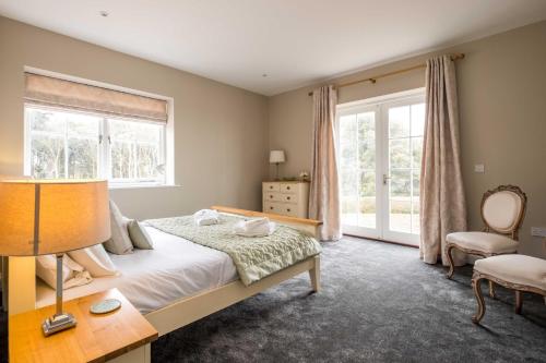 a bedroom with a bed and a window at The Dower House in Sizewell