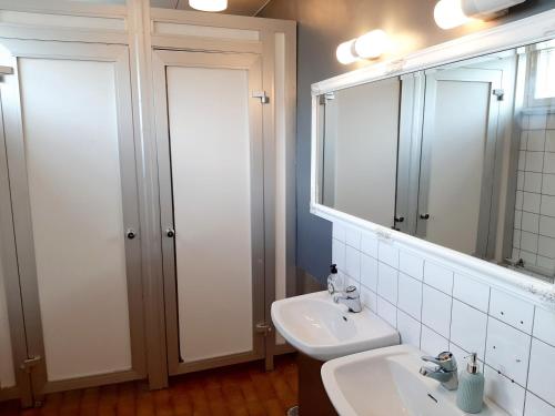 a bathroom with a sink and a mirror at Center Hostel Kaatrahovi in Lieksa