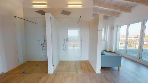 a bathroom with two showers and a blue couch in a room at Beach'n'Sea Wohnung 8 in Grömitz