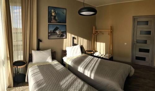 a bedroom with two beds and a window at Авиатик in Zhytomyr