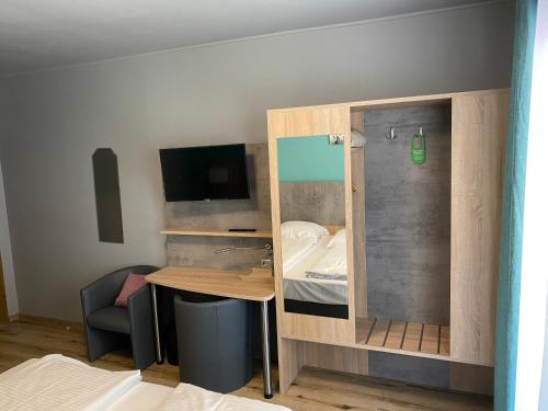 a small room with a small desk and a bed at Hotel Blüchertal in Bacharach