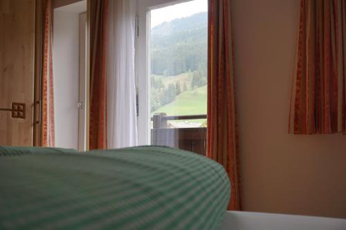 a bedroom with a bed and a window with a view at Peterlhaus in Kleinarl