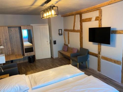 a hotel room with two beds and a tv at Hotel Blüchertal in Bacharach