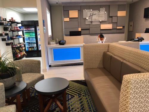 a waiting room with a couch and a tv at Holiday Inn Express Metropolis by IHG in Metropolis