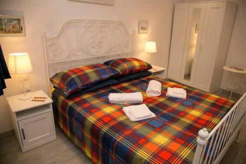 a bedroom with a bed with two towels on it at Giripaso Apartment in Florence