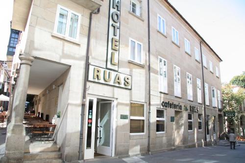a large building with a sign on the side of it at Hotel Restaurante Rúas in Pontevedra