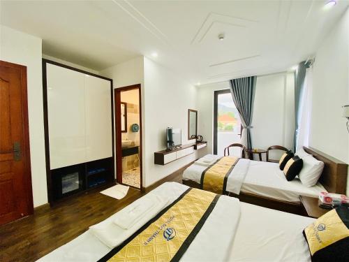 a hotel room with two beds and a fireplace at HOTEL ĐỨC THÀNH 2 in Con Dao