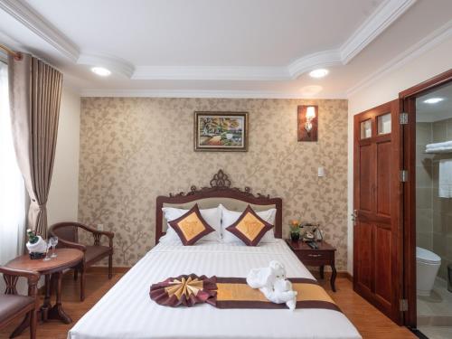 a bedroom with a bed with a teddy bear on it at Air Star Hotel in Ho Chi Minh City