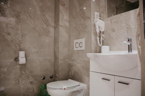 a bathroom with a toilet and a sink at Hotel Villa Matic in Neum