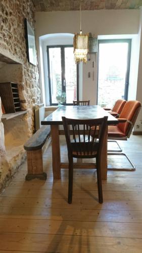 une salle à manger avec une table et des chaises et une cheminée dans l'établissement La maison du brocanteur, à Aiguèze