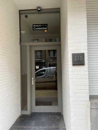 a door to a building with a sign on it at modern appartement near beach in Knokke in Knokke-Heist