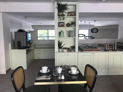 a kitchen with a table and chairs and a kitchen with at Hôtel La Villa Port d'Antibes & Spa in Antibes