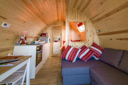 a living room with a couch in a tiny house at Suil na Mara Pod in Lochinver