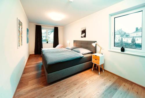 a bedroom with a bed and a window at Ferienwohnungen schulerundmeyer in Bernkastel-Kues