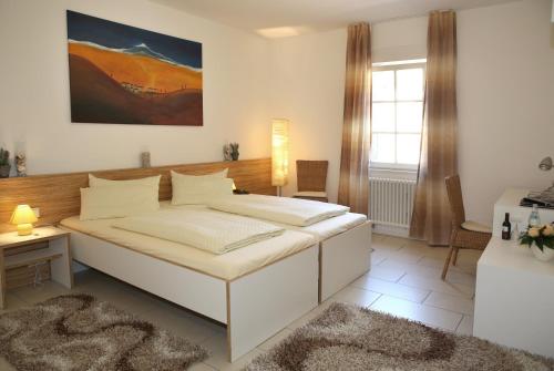 A bed or beds in a room at Landhotel Sickinger Hof