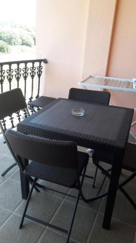 a black table and chairs in a room at Panoramico Playa de Altar I in Barreiros