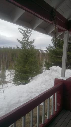 a view of a snow covered yard from a porch at Metsorinne in Kotila