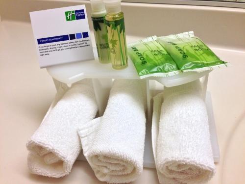 a group of towels and other products on a shelf at Holiday Inn Express & Suites Burlington - Mount Holly by IHG in Westampton Township