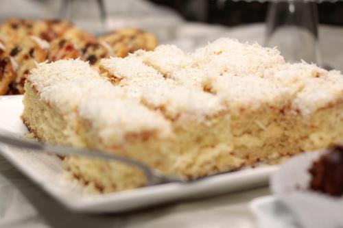a piece of cake on a plate on a table at Sumatra Hotel e Centro de Convenções in Londrina