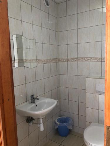 a bathroom with a sink and a toilet at Azymut in Władysławowo
