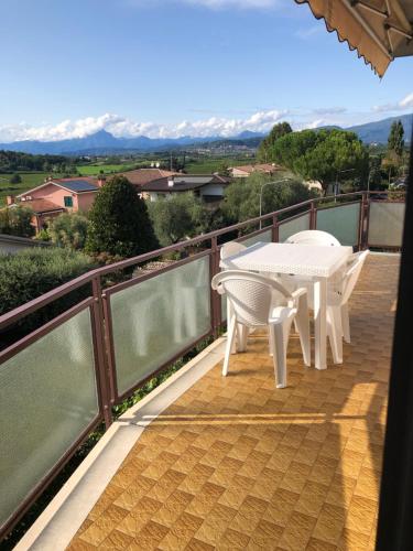 a balcony with a table and chairs on it at Casa Magnolia in Pastrengo