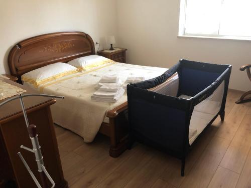 a bedroom with a large bed and a chair at Casa Magnolia in Pastrengo