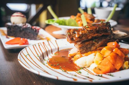 a plate of food with meat and fruit on a table at Forty Four Main Street in Swords