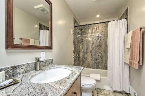 a bathroom with a sink and a toilet and a mirror at Ideally Located San Francisco Bay Home with Sunroom! in Alameda