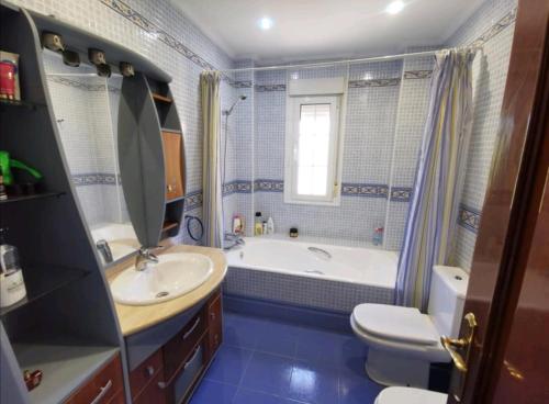 a bathroom with a tub and a sink and a toilet at villa Santa Ana in Laredo