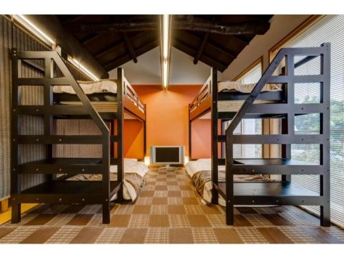 a room with two bunk beds and a tv at Shinjuku Garden House / Vacation STAY 81151 in Tokyo