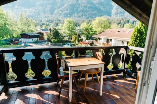 stół i krzesła na balkonie z widokiem w obiekcie Riverside Apartment w Garmisch Partenkirchen