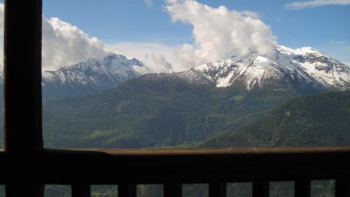 a view of a snow covered mountain from a window at Hotel Ristoro Vagneur in Saint Nicolas