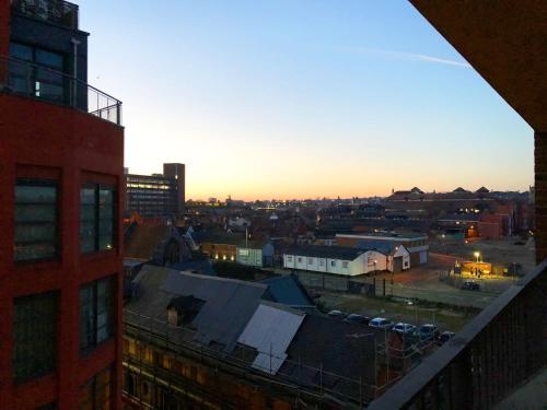 a view of a city at sunset from a building at Spacious Luxury Waterfront Apartment in Ipswich