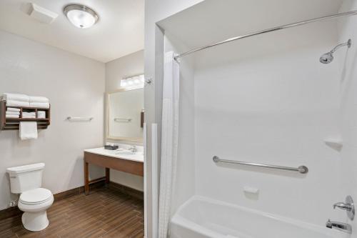 a bathroom with a toilet and a sink at La Quinta by Wyndham Houston NW Beltway8/WestRD in Houston