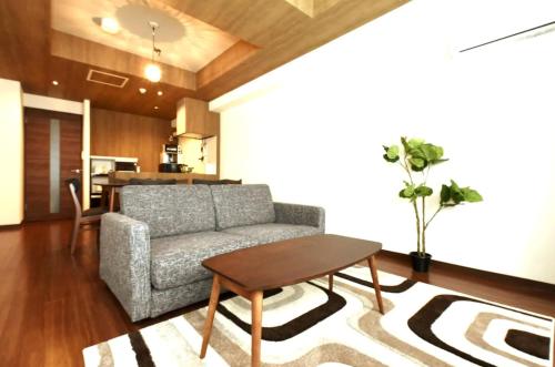 a living room with a couch and a table at Hills Garden Hondori / Vacation STAY 7576 in Sapporo