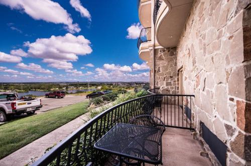 a balcony with a bench on the side of a building at La Quinta by Wyndham Marble Falls in Marble Falls