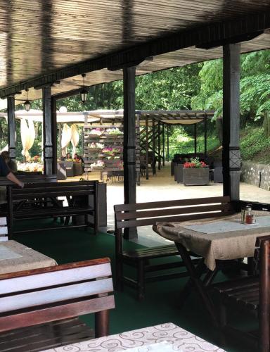 a pavilion with benches and tables in a park at Jezero Kudrec in Smederevska Palanka