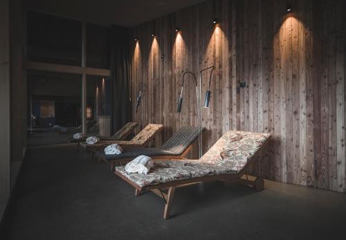 a row of benches in a room with lights at Niedermairhof in Brunico