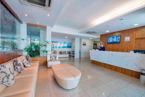 a lobby of a hospital with a waiting room and a counter at Maredomus Hotel in Fortaleza
