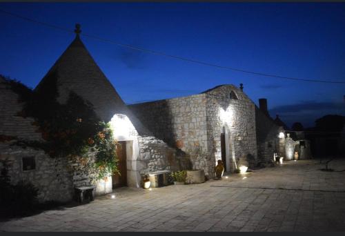 a stone building with lights on it at night at Bed & breakfast vecchia vallata in Gioia del Colle