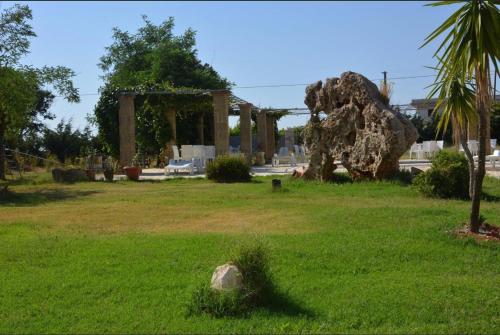 a park with a large rock in the grass at Bed & breakfast vecchia vallata in Gioia del Colle